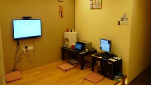 A room with a desk, two monitors, a coffee machine, and a wall clock. - Hotel O V Stay Guesthouse (George Town)