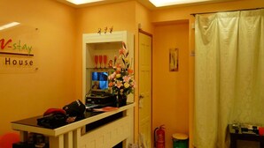 A hotel reception area with a counter, a fire extinguisher, and a curtain. - Hotel O V Stay Guesthouse (George Town)