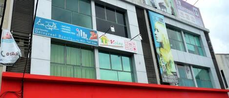 A building with multiple signs, including one for 'Eve Taylor' and another for 'V-stay'.
