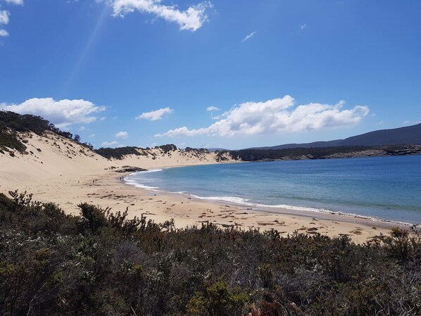 Beach nearby, white sand, beach towels