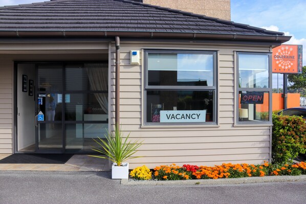Un edificio con un cartel de 'VACANCY', una zona de recepción y una señalización que indica 'COLERAINE'.
