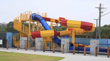 A water park with multiple slides and a staircase.