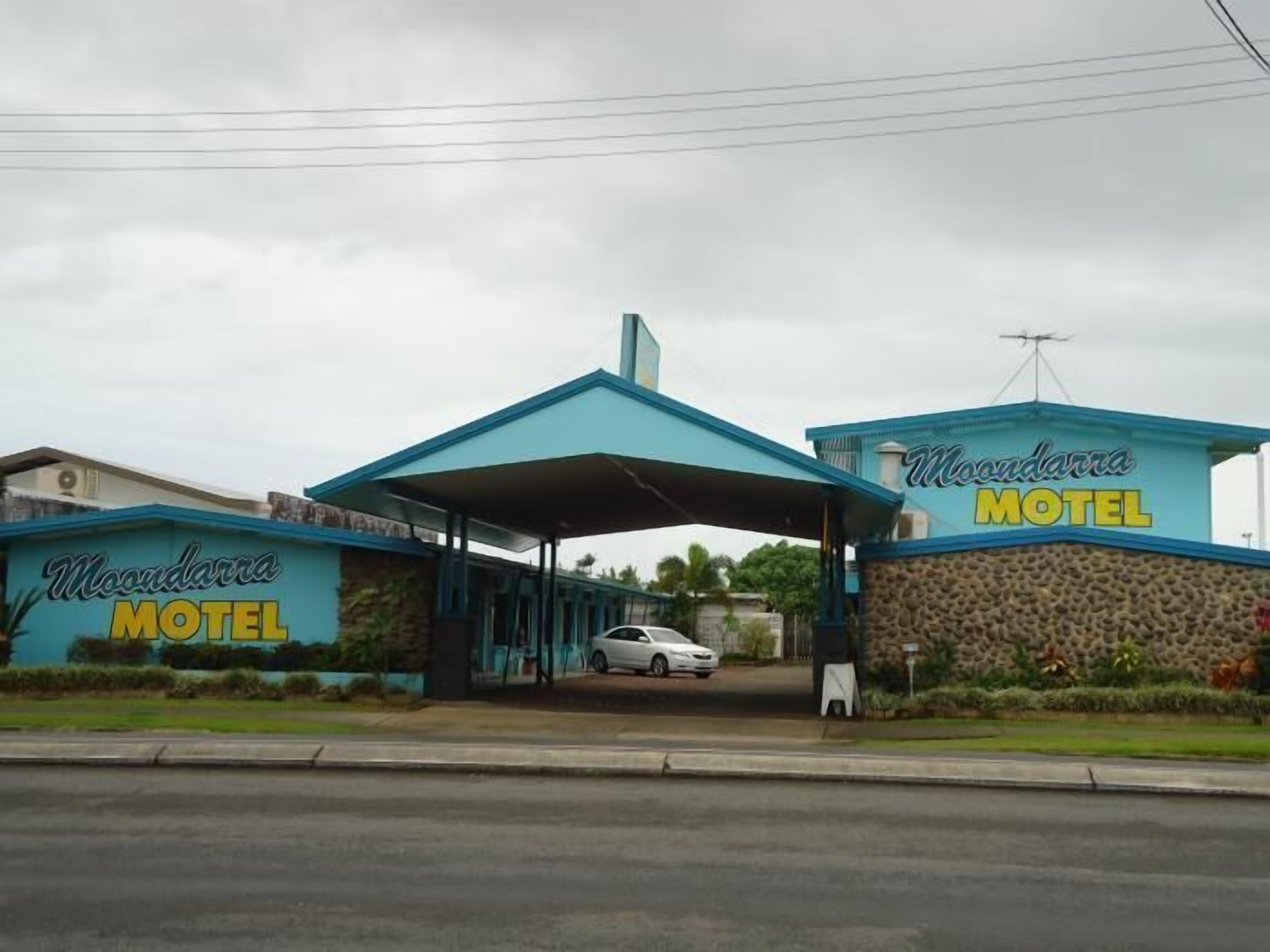 The exterior of Moondarra Motel with a covered entrance and a stone facade.