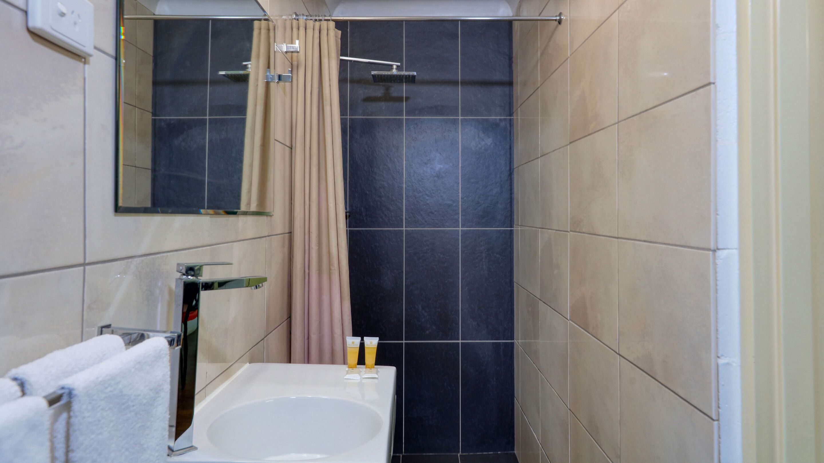 A bathroom with a bathtub, a shower, and a toilet.