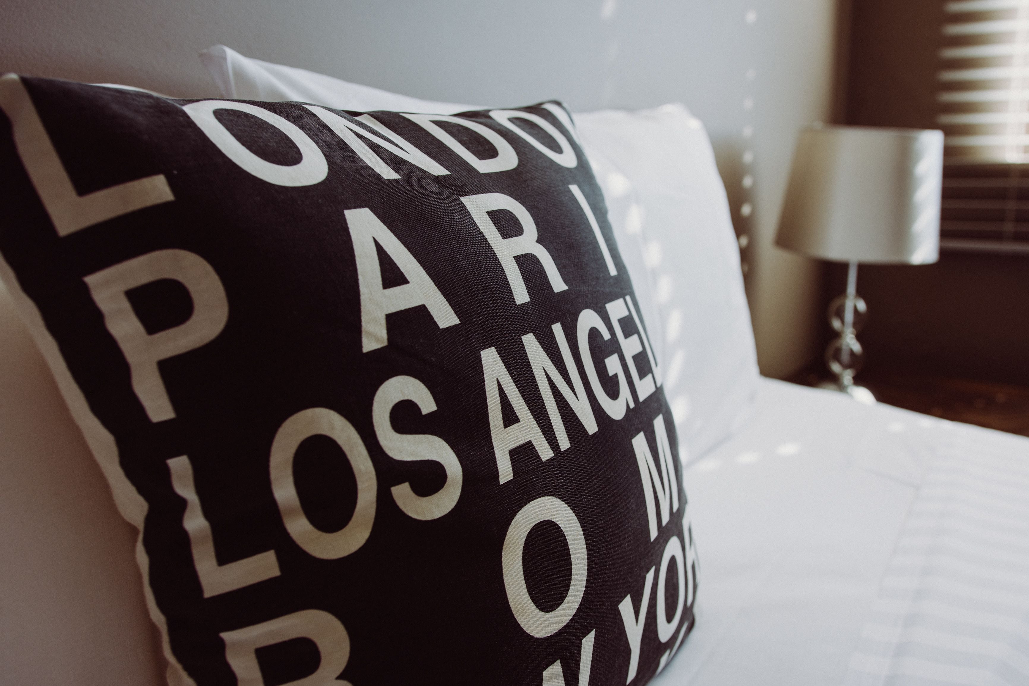 A pillow with "LONDON PARIS LOS ANGELES" text.