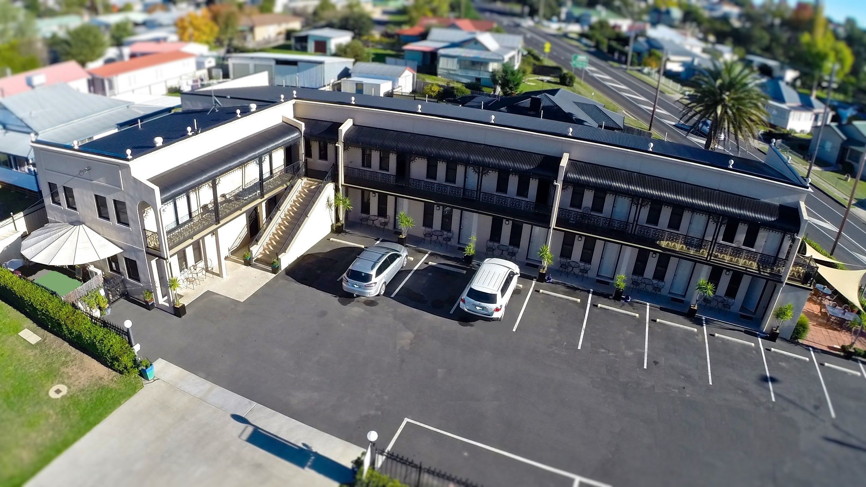 A two-story building with a parking lot in front.