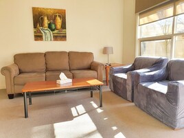 Deluxe Family Apartment 9 | Living area | Flat-screen TV, DVD player