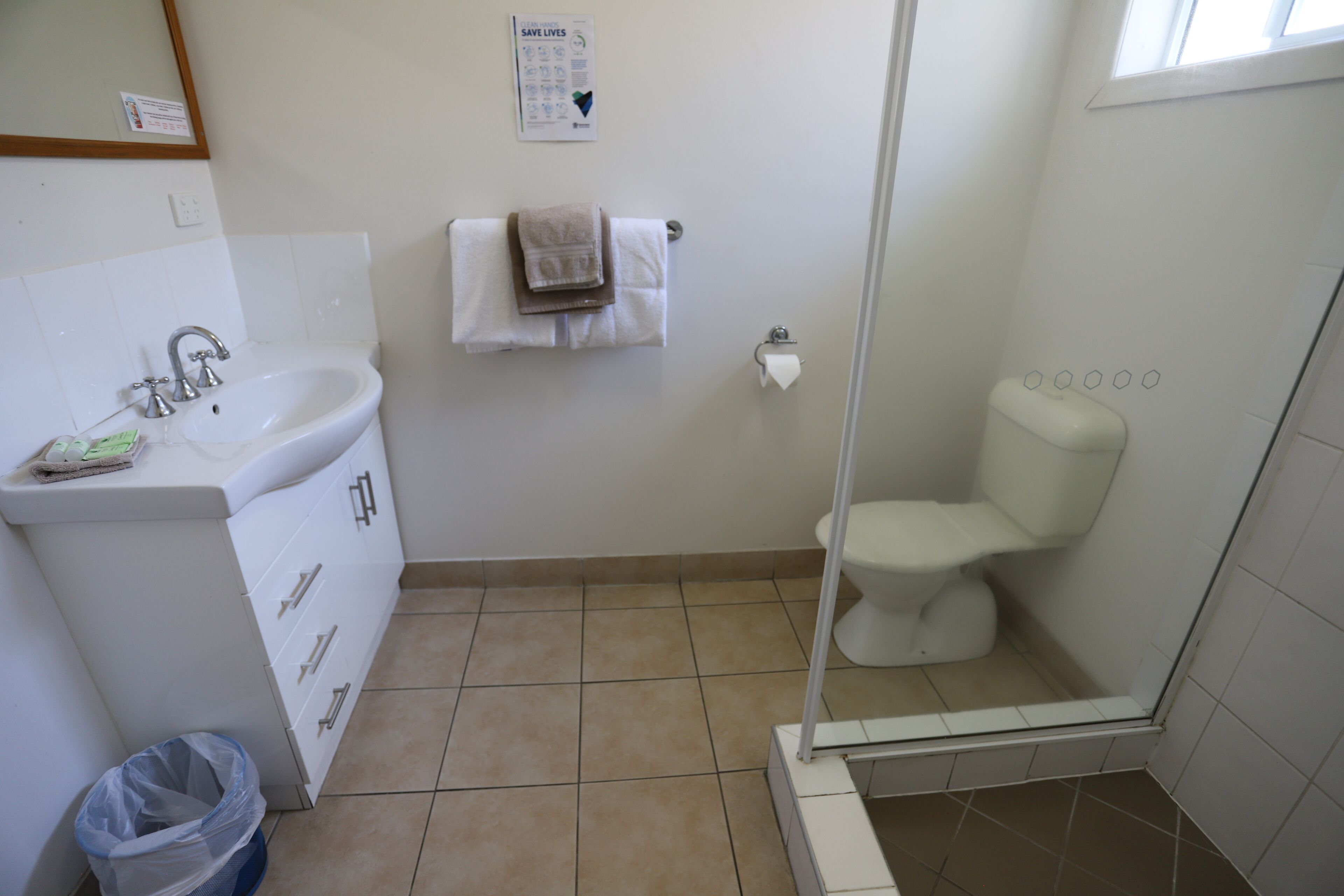 A bathroom with a sink, toilet, and shower.