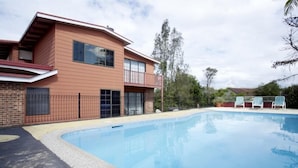 A two-story house with a swimming pool, a balcony, and a fenced yard. - Riverview Motor INN Taree (Taree)