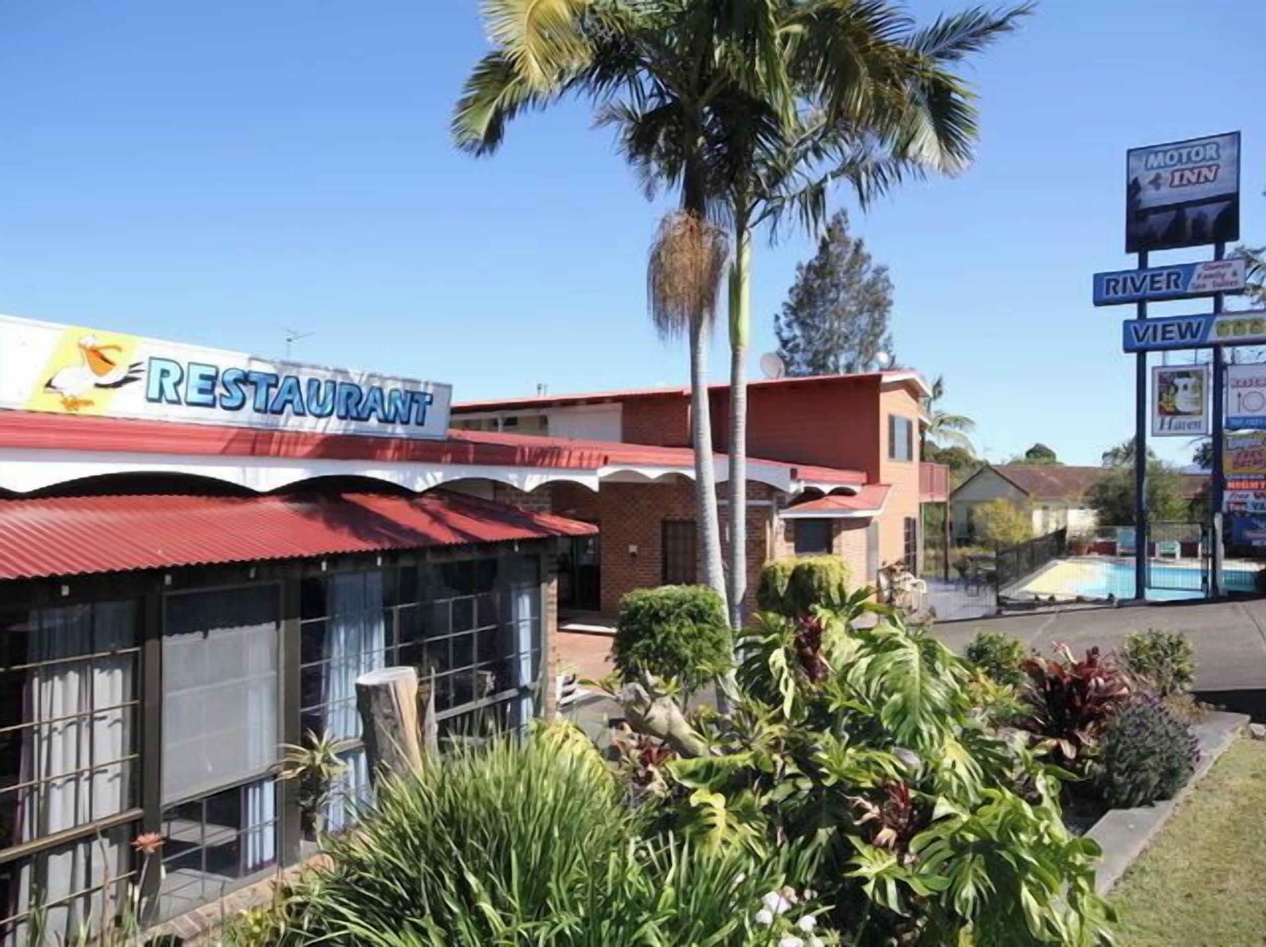 A restaurant with a red roof and a signboard.