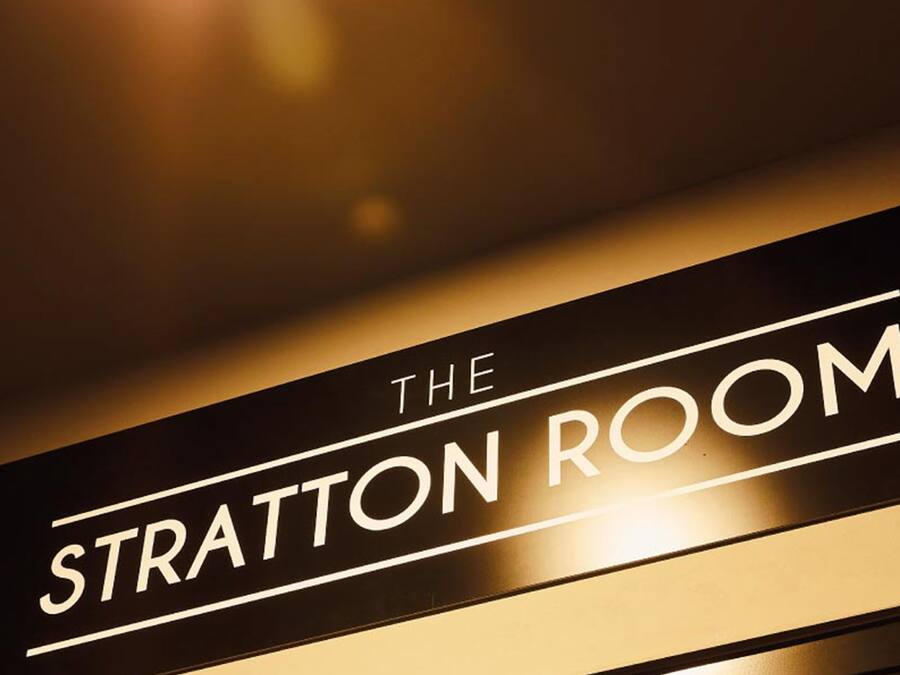 A sign with the text "THE STRATTON ROOM".