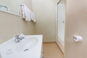 A bathroom with a white sink, a mirror, a towel rack, and a toilet paper holder. - Ingenia Holidays Noosa North (Tewantin)