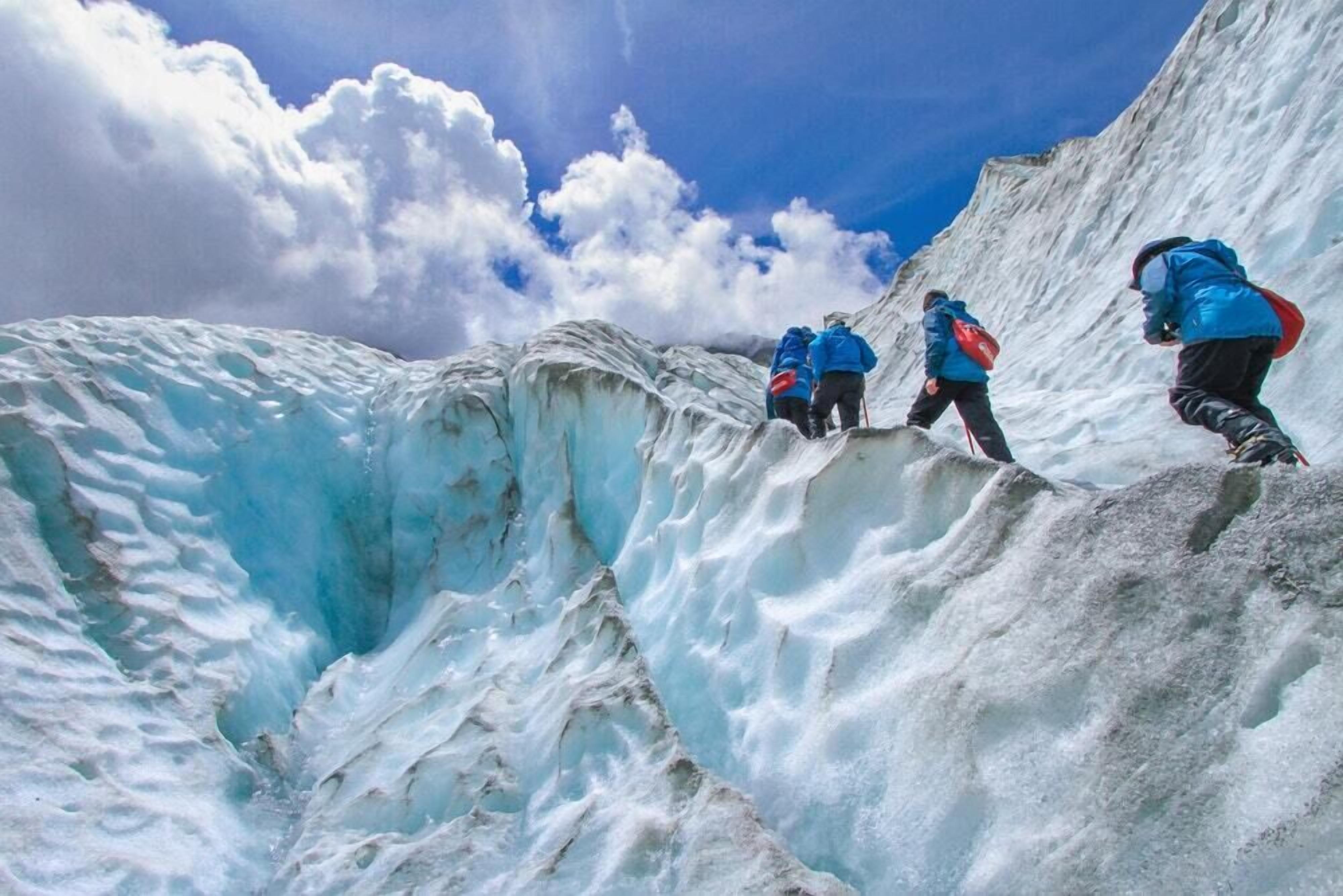 A glacier with people climbing.