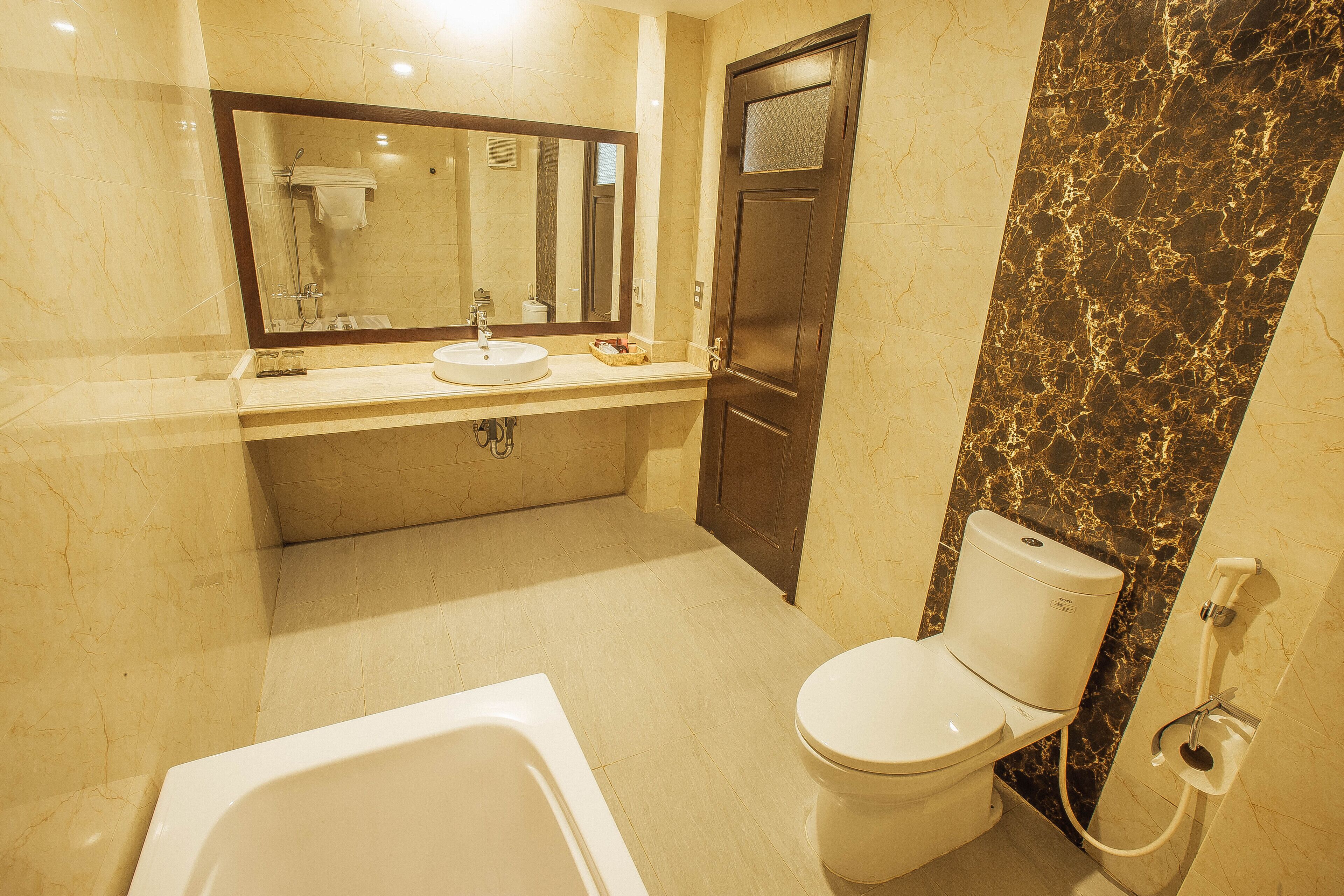 A bathroom with a bathtub, toilet, and sink.