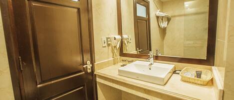 A bathroom with a white sink, a mirror, and a shower.