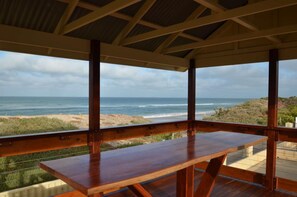 A wooden deck with a view of the ocean and beach. - Sunset Beach Holiday Park (Sunset Beach)