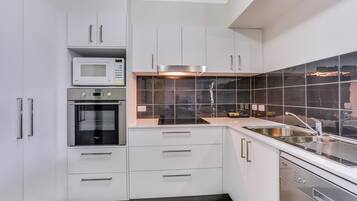 Rosalie Two-Bedroom Apartment | Private kitchen | Full-size fridge, microwave, stovetop, coffee/tea maker