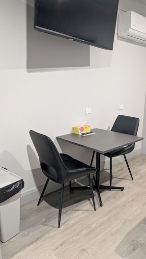 Deluxe King Suite | Desk, laptop workspace, blackout drapes, free WiFi