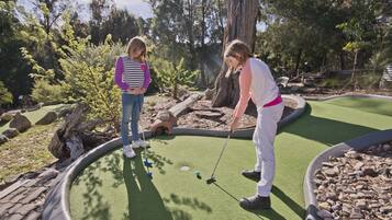 Play a round of golf amidst lush surroundings and scenic views.