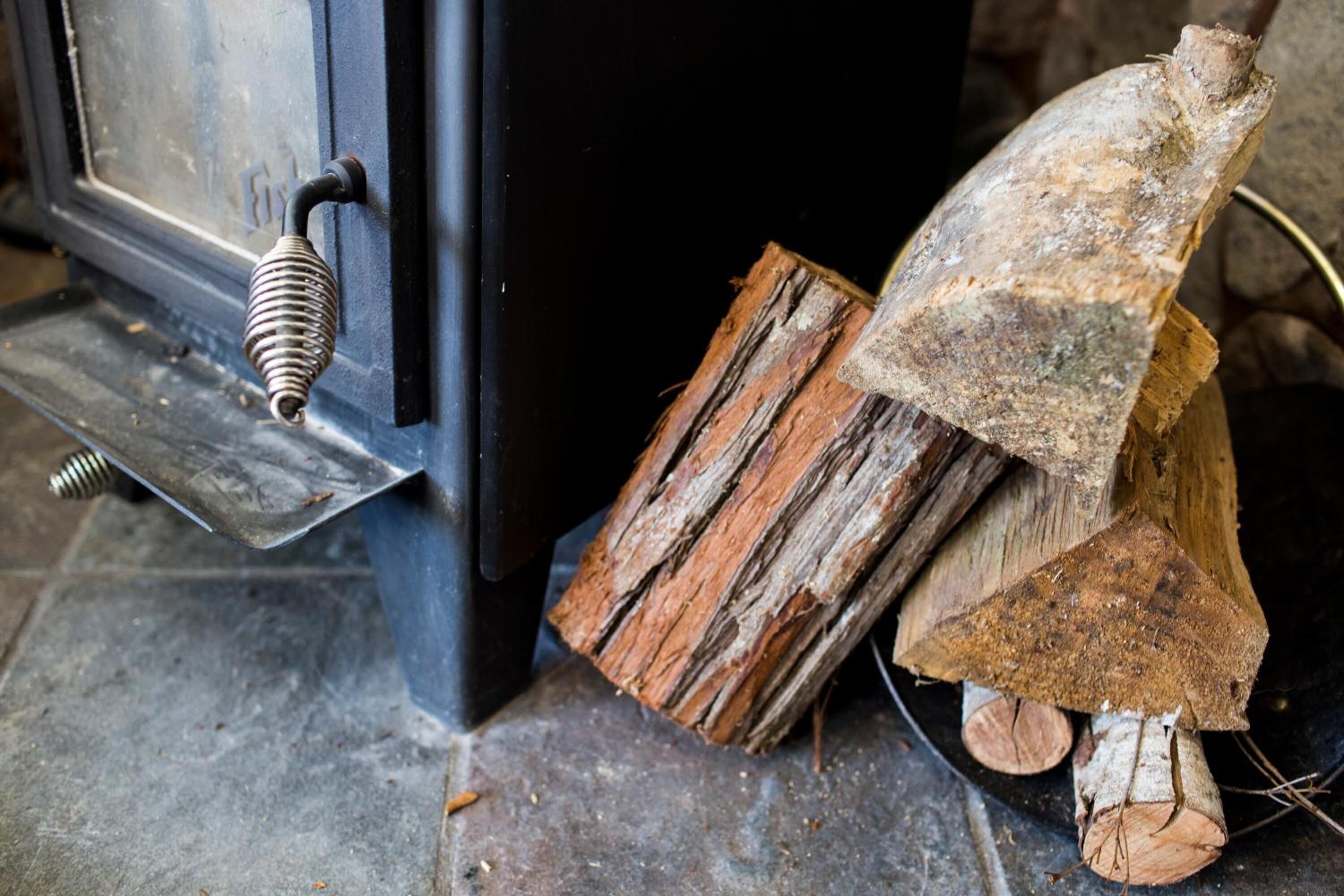 A rustic wooden door with a metal handle and a metal latch.