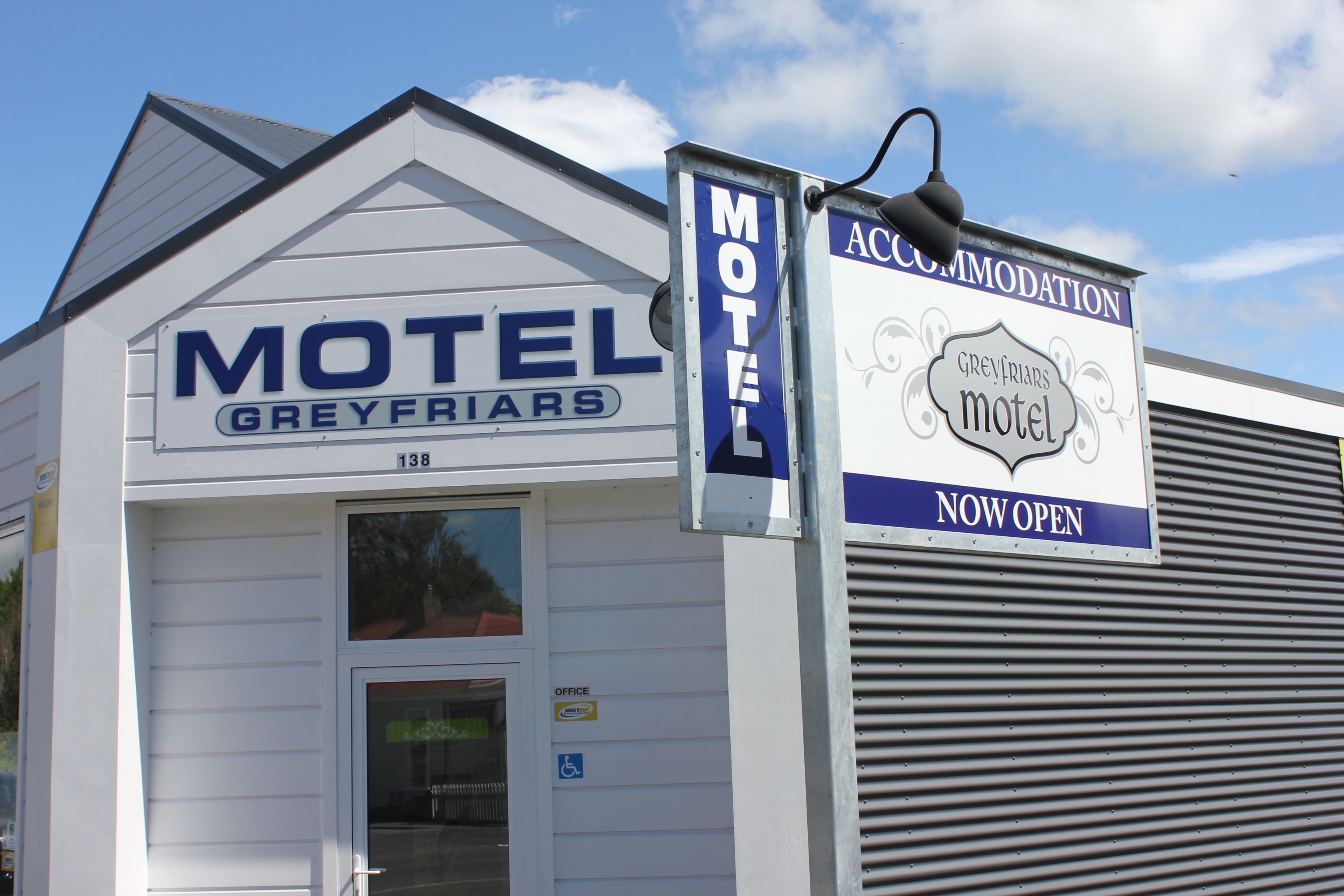 A motel sign with 'Motel Greyfriars' and 'Greyfriars Motel' written on it.