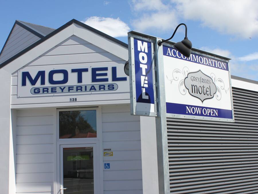 A motel sign with 'Motel Greyfriars' and 'Greyfriars Motel' written on it.