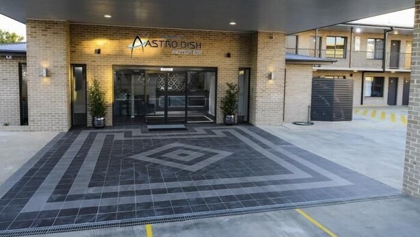 A modern building with a sign reading "ASTRO DISH." - Aastro Dish Motor Inn (Parkes)