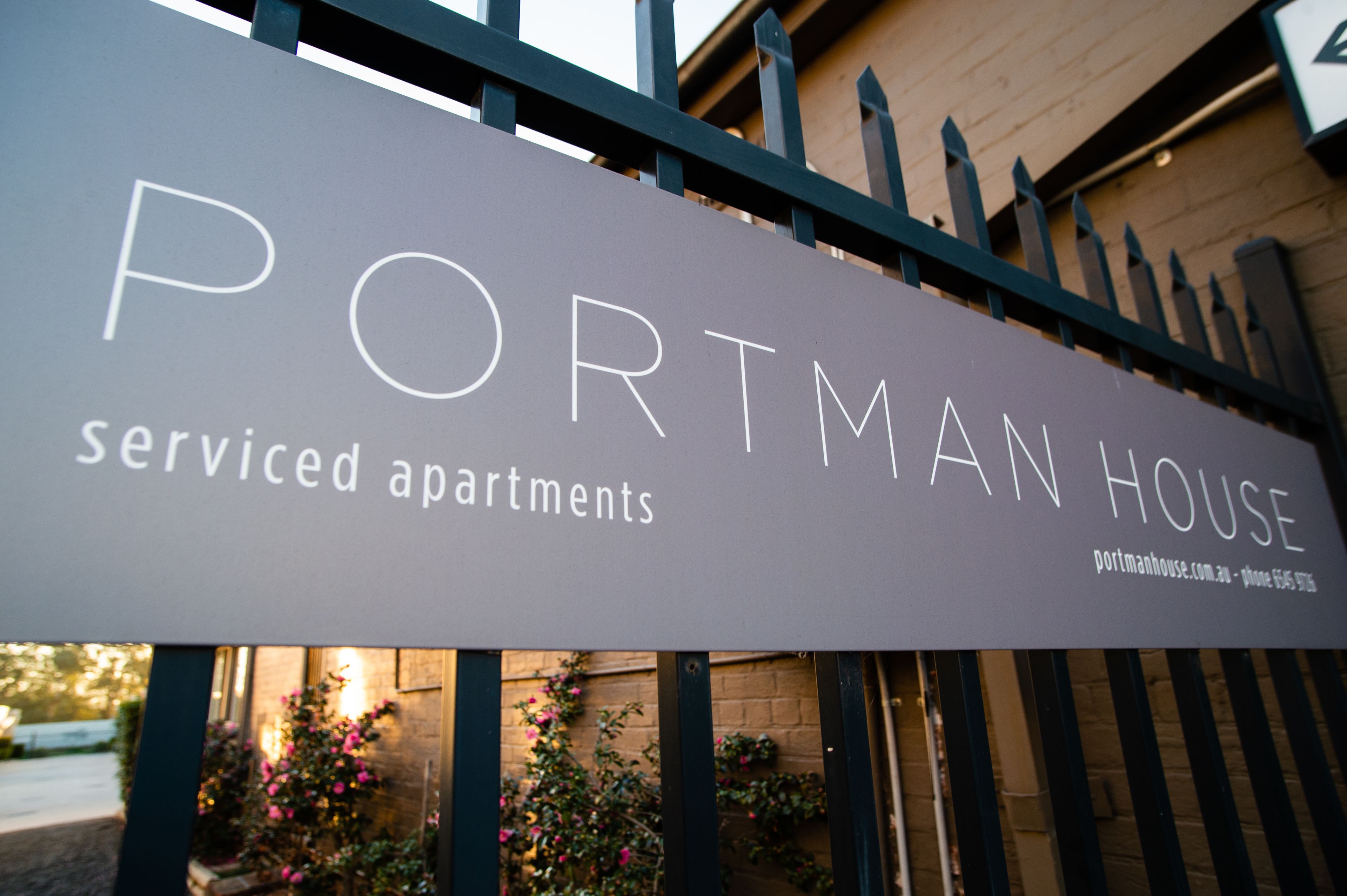 A sign for 'Portman House' indicating serviced apartments.