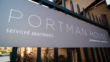 A sign for 'Portman House' indicating serviced apartments.