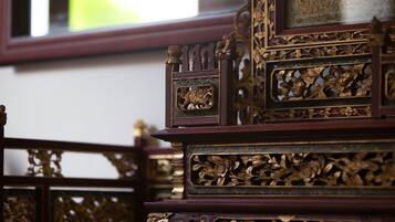 A close-up of ornate wooden furniture with intricate carvings.