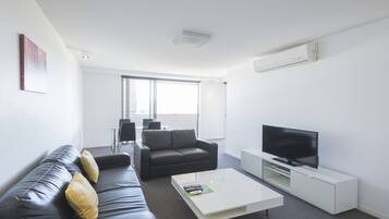 Deluxe Two Bedroom Apartment | Living area | TV, iPod dock