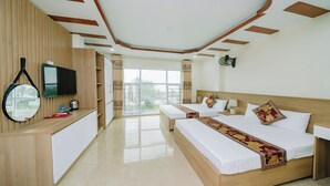 A hotel room with a wooden bed, a TV, a desk, and a large window. - My Ngoc Hotel Catba (Hai Phong)