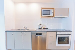 Una cocina moderna con lavavajillas, microondas y horno incorporados.