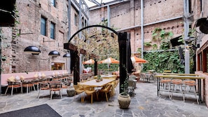 Enjoy dining al fresco under the shade of umbrellas and amidst lush greenery.
