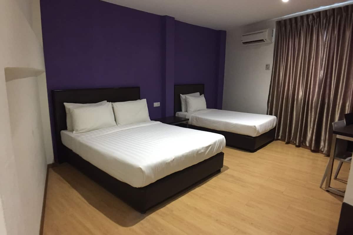 deluxe triple room | in-room safe, desk, blackout curtains, iron/ironing board