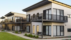 A modern multi-story residential building with balconies, large windows, and a landscaped outdoor area. - Berri Hotel (Berri)