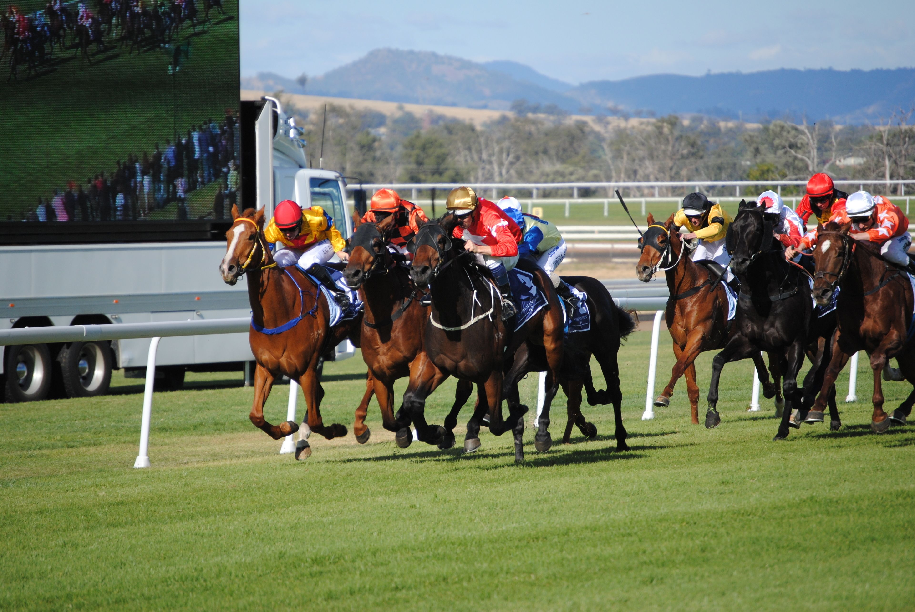 A horse race with jockeys on horses.