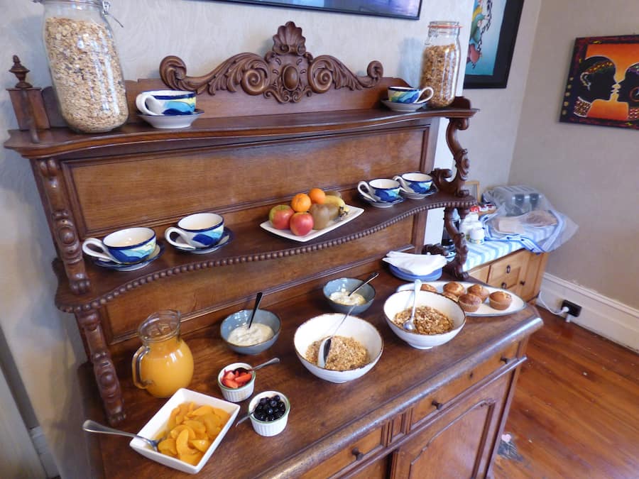 A breakfast buffet setup with various food items and beverages.