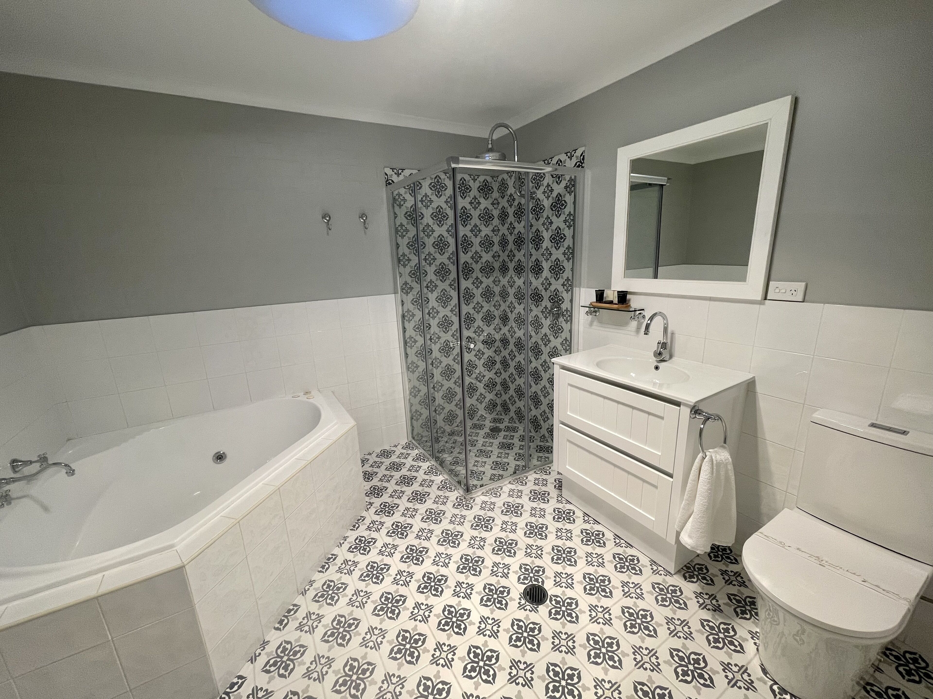 A bathroom with a bathtub, a shower, a sink, and a toilet.