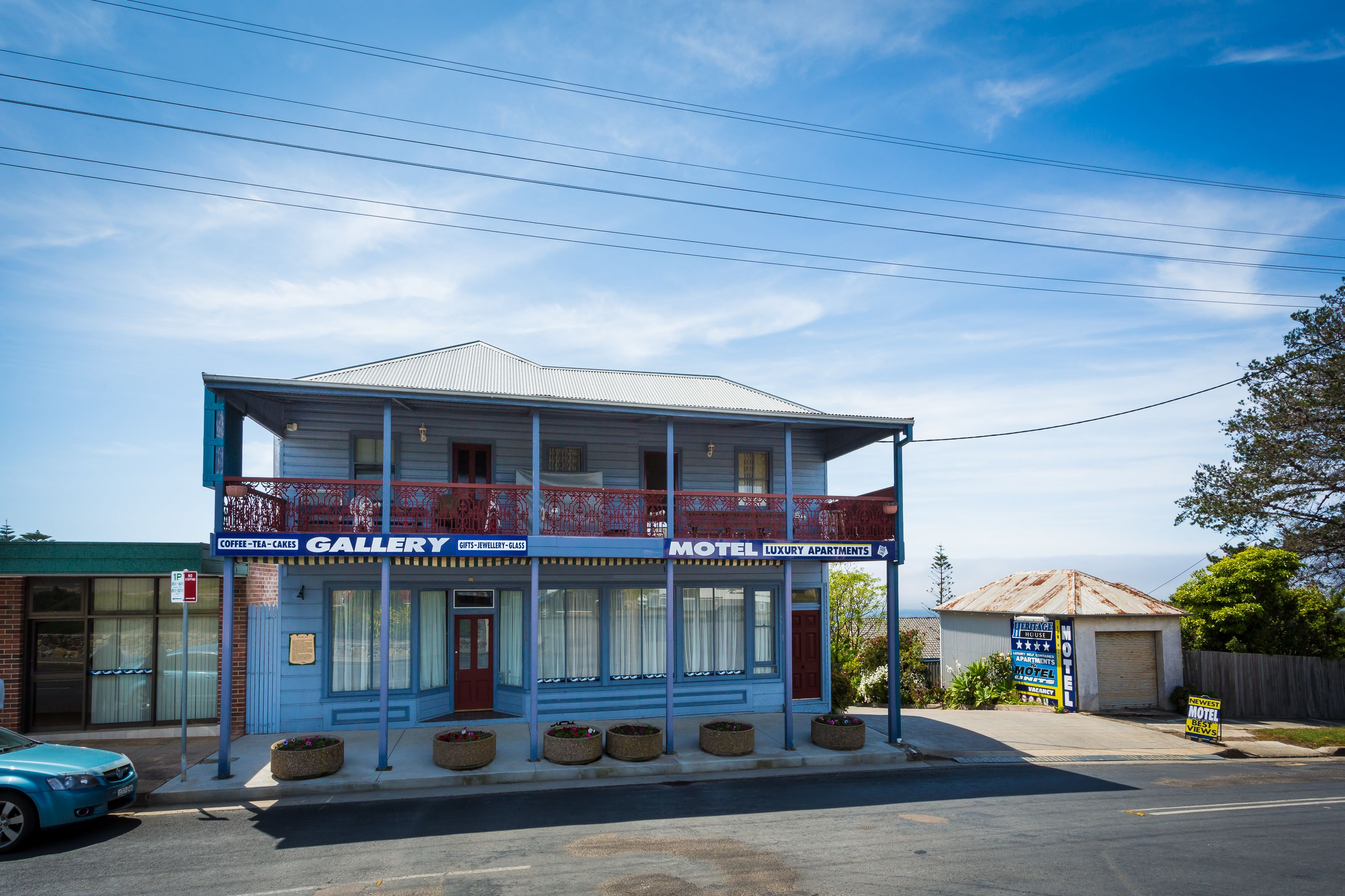 A two-story building with a gallery on the ground floor and a motel on the upper floor.