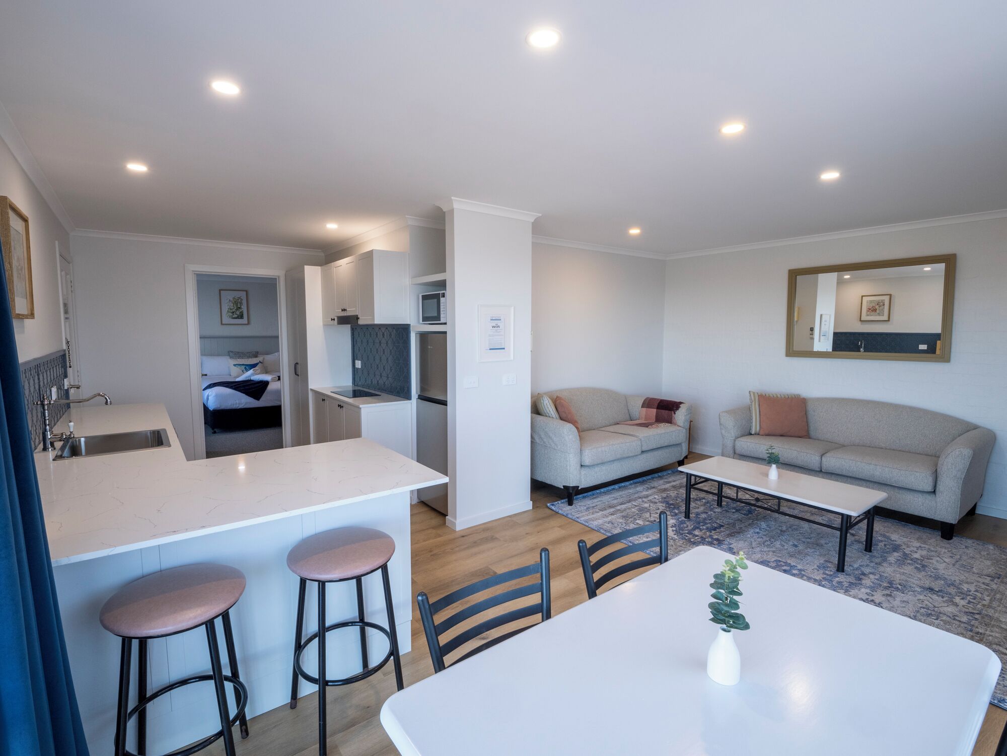 A modern apartment with a kitchen, dining area, and living room.