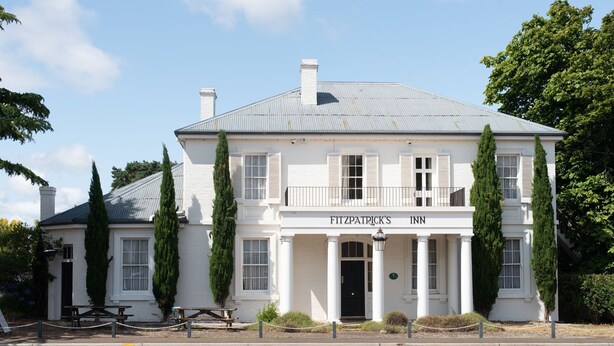 A white building with a sign reading "FITZPATRICK'S INN".