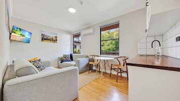 Economy Apartment | Living area | 90-inch TV with digital channels