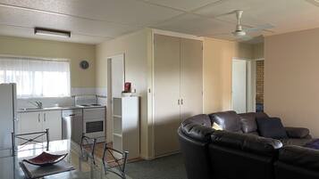Two Bedroom Apartment with Balcony | Living area | 42-inch Smart TV with cable channels