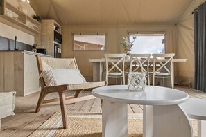 A cozy room with a wooden floor, a round white table, a woven chair, and a white lamp. - BIG4 Ingenia Holidays Inverloch (Inverloch)