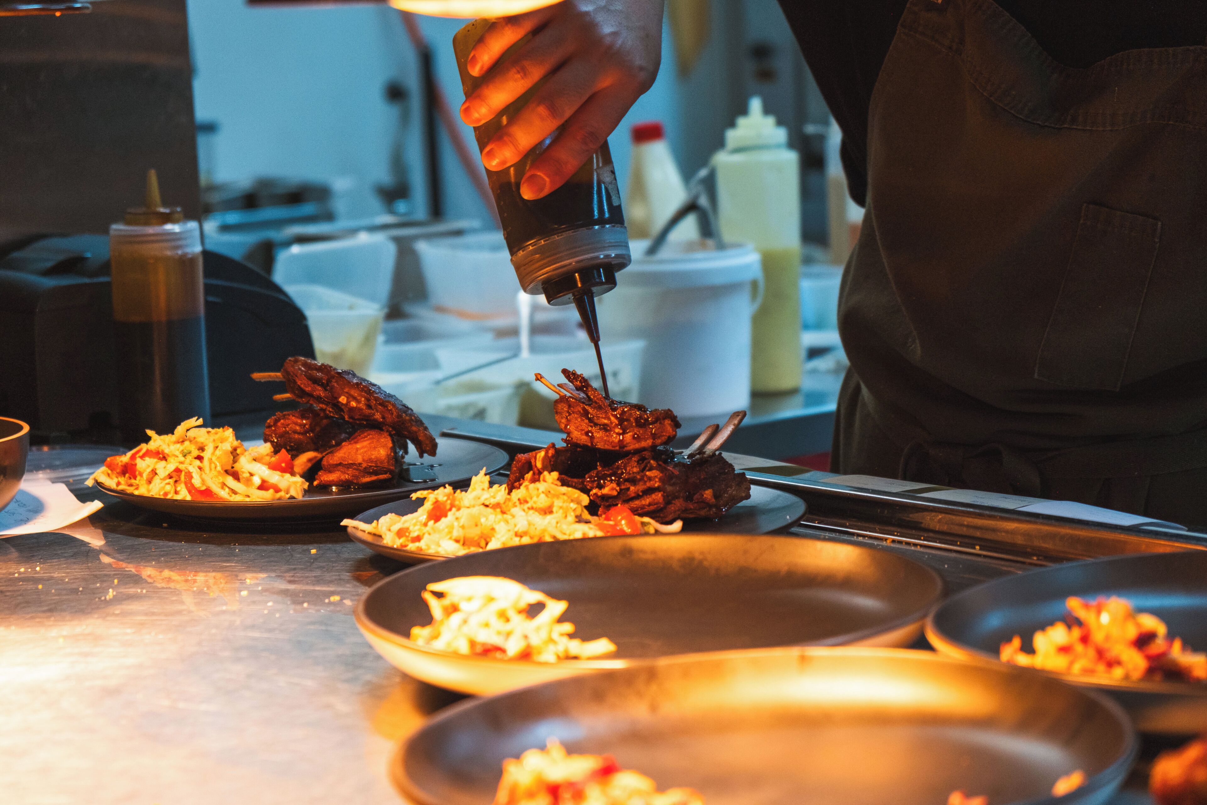 A kitchen counter with various dishes, including what appears to be a meat dish and a salad.