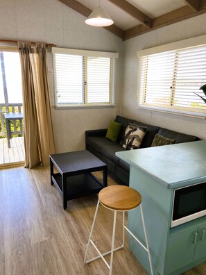 Beachfront Holiday Cabin (1 Queen, 1 Bunk and 1 Single Bed) | Living area | Flat-screen TV
