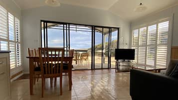 Beach House -Executive - 1 queen, 1 double & 1 single | Living area | Flat-screen TV