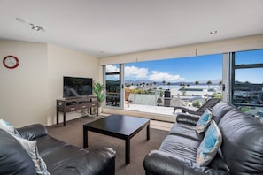 Presidential Apartment, 3 Bedrooms, Sea View | Living area | 40-inch TV with satellite channels - Esplanade Apartments (Whitianga)