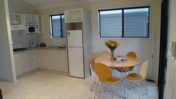 Standard Suite, 2 Bedrooms, Kitchen (Waterview Villa) | Private kitchen | Microwave, stovetop, coffee/tea maker, cookware/dishes/utensils